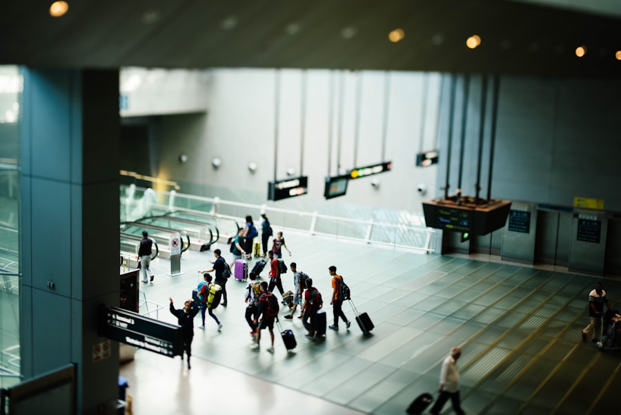 Travellers with luggage crossing an airport terminal concourse